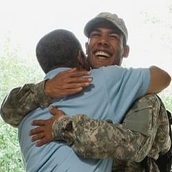 Soldier hugging a family member