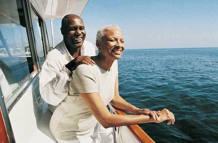 A black couple on a boat enjoying a sunny day