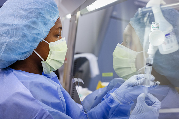 healthcare worker prepares a syringe