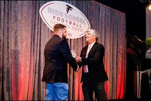 men shaking hands at high school football awards