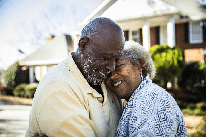 elderly couple hugging