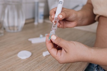 person preparing to take weight loss drug shot