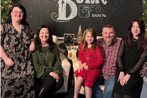 Patient Astra poses with her family