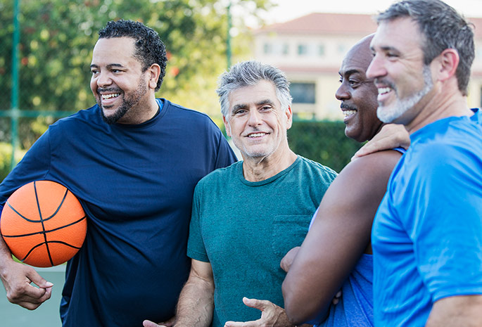 group of men playing basketball together