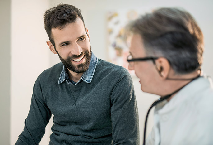 Male patient smiles at doctor