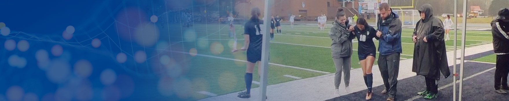 physical therapist on the field with a patient