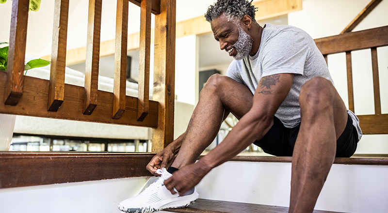 senior man tying running shoes