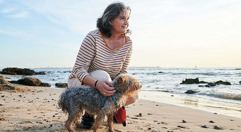 woman with dog on the beach