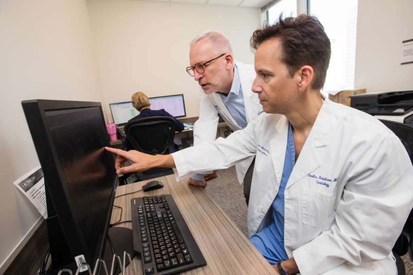 Doctors look at patient scans