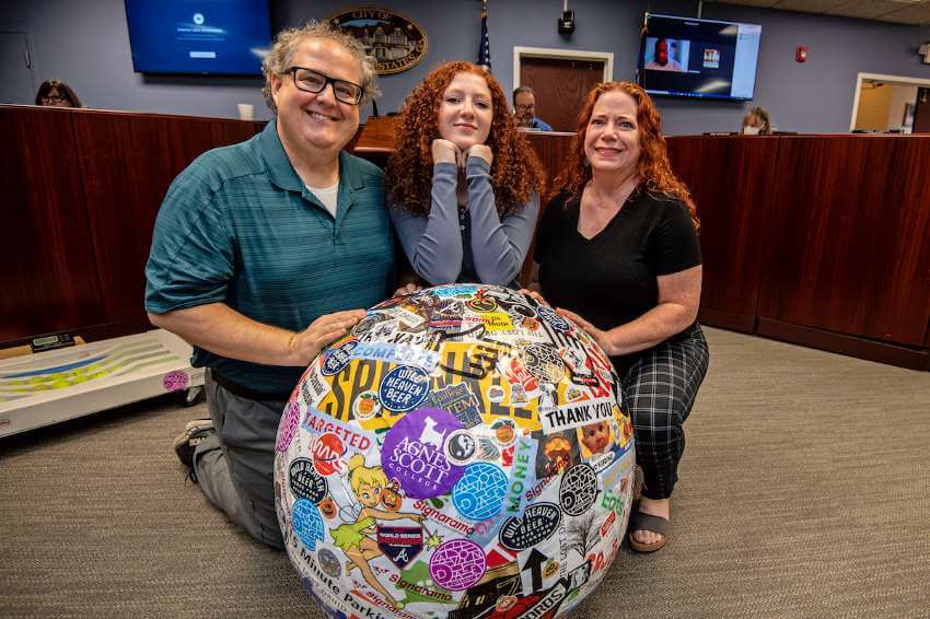 The Moricle family, Wade, Sofie and Julie, pose with the 600-pound sticker ball