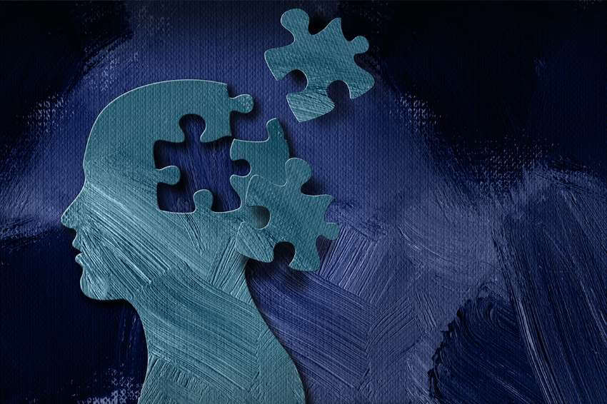 a painted blue profile of a person with two displaced puzzle pieces