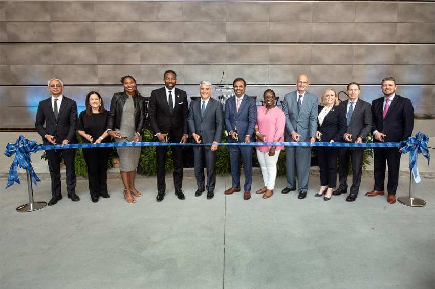 representatives from Emory and the community cut a blue ribbon together