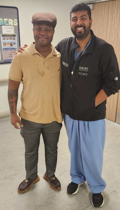 Dave with his arm around Roberts, smiling