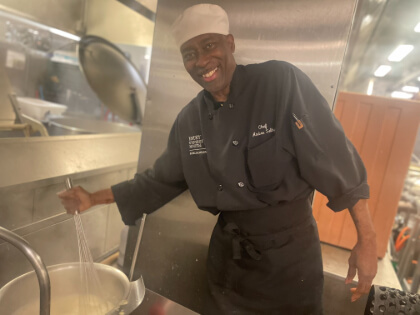 Chef Andre Selby filling a pot with water
