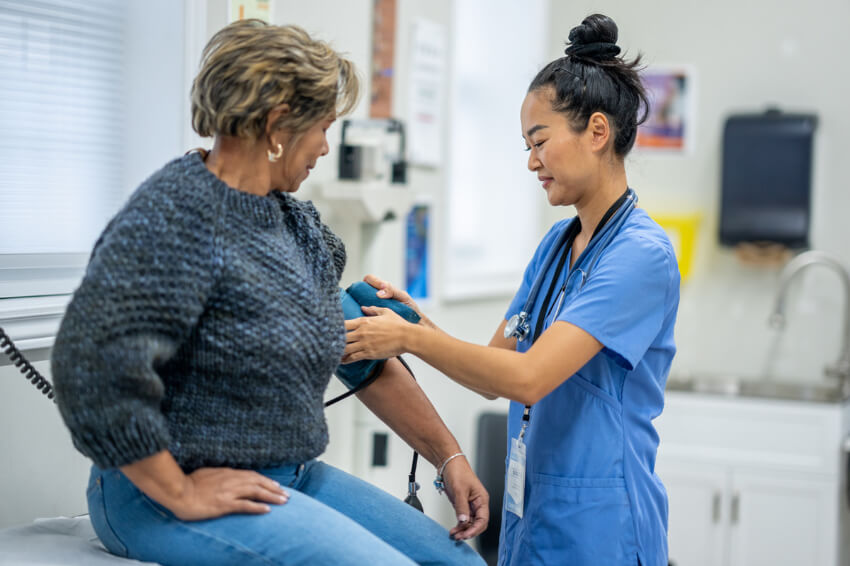 nurse takes patient's blood pressure