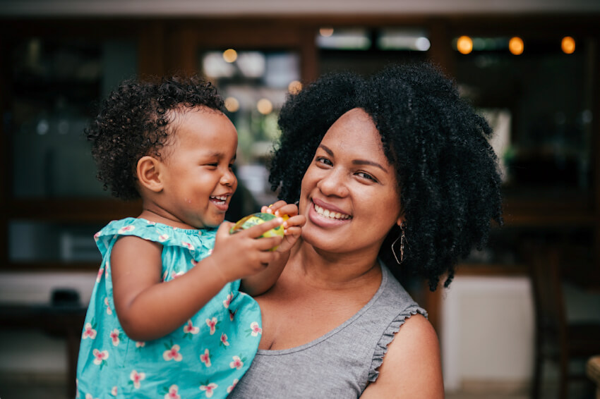 mother holding her happy toddler