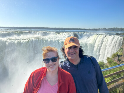 Jessica and Douglas standing in front of Iguazu Falls in Brazil