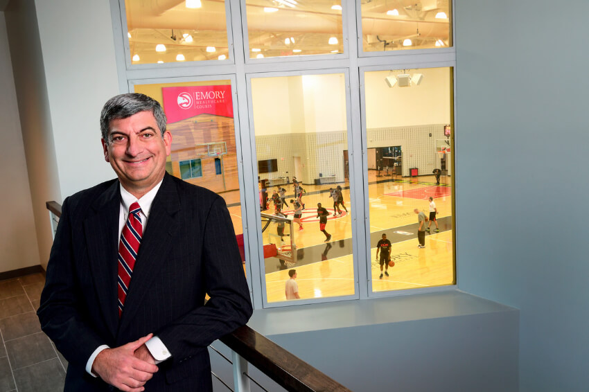 Scott Boden standing in a hall overlooking a basketball court
