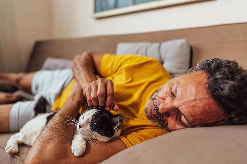 A man with sleep apnea while holding a cat