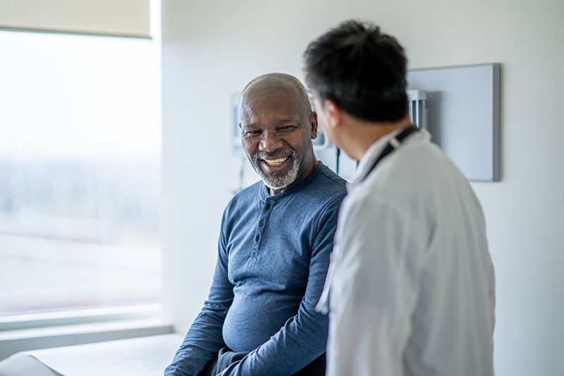 Patient listening to doctor’s explanation inside exam room