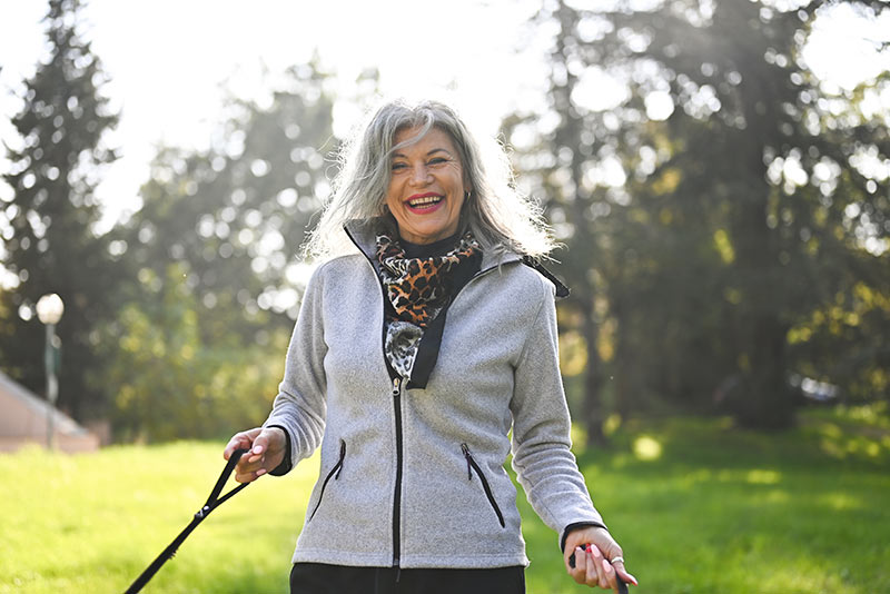 elderly woman walking dogs