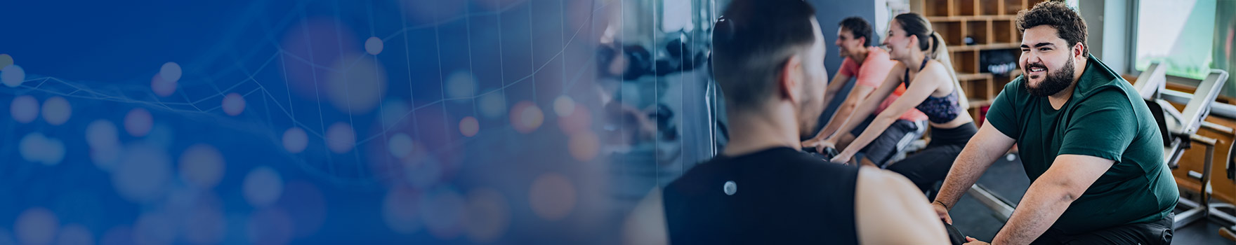 man at the gym talking to another man while working out