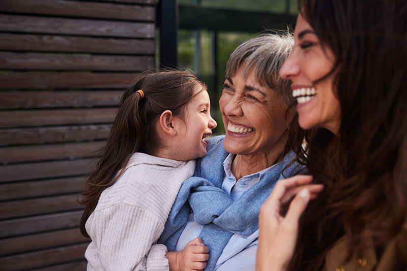grandmother, daughter and granddaughter together outdoors