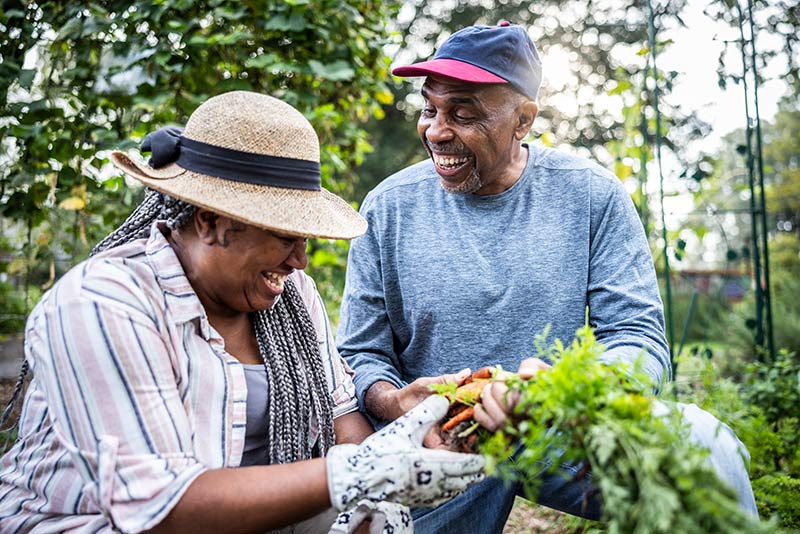 elderly couple gardening outdoors